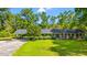 Charming brick ranch with a covered carport, lush lawn, and mature landscaping at 1032 Chelsey Circle, Conway, SC 29526