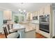 Well-lit kitchen with granite countertops, stainless steel appliances, and island with breakfast bar at 1032 Chelsey Circle, Conway, SC 29526