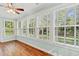 Bright sunroom with hardwood floors and several large windows with backyard views at 1032 Chelsey Circle, Conway, SC 29526