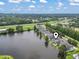 Overhead view of homes and a lake with surrounding trees under a partly cloudy sky at 1048 Meadowoods Dr., Murrells Inlet, SC 29576
