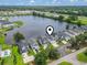 Aerial view of lakeside homes with lush trees and landscaping, as well as a view of the highway in the distance at 1048 Meadowoods Dr., Murrells Inlet, SC 29576