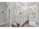 Bright bathroom with a dual sink vanity, modern fixtures, and decorative accents at 1048 Meadowoods Dr., Murrells Inlet, SC 29576