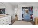 Bedroom closet with blue accent paint, storage baskets, dresser, open door, and view to another room at 1048 Meadowoods Dr., Murrells Inlet, SC 29576