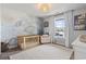 Bedroom with carpet, a crib, chair, side table, stylish light fixture, and a window with lake view at 1048 Meadowoods Dr., Murrells Inlet, SC 29576