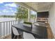 Inviting covered porch with string lights, outdoor seating, and a tranquil lake view for relaxing at 1048 Meadowoods Dr., Murrells Inlet, SC 29576