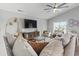 Bright living room with high ceilings, a ceiling fan, and a large sectional sofa at 1048 Meadowoods Dr., Murrells Inlet, SC 29576
