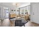 Modern living room with hardwood floors, tan couch, wooden shelving, and a lake view at 1048 Meadowoods Dr., Murrells Inlet, SC 29576