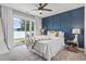 Bedroom with a lake view, paneled accent wall, ceiling fan, bedside tables, and sliding glass doors to a patio at 1048 Meadowoods Dr., Murrells Inlet, SC 29576