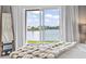 Bedroom featuring sliding glass doors with a lake view, a cozy throw blanket and white sheer curtains at 1048 Meadowoods Dr., Murrells Inlet, SC 29576