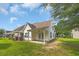 Charming backyard with a covered patio and double french doors, set against a lush green lawn at 1057 Stanton Pl. # 1057, Myrtle Beach, SC 29579