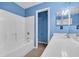 The blue bathroom features a tub, toilet, and vanity at 1057 Stanton Pl. # 1057, Myrtle Beach, SC 29579