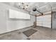 Spacious garage featuring overhead storage cabinets, concrete flooring, and a white garage door at 1057 Stanton Pl. # 1057, Myrtle Beach, SC 29579