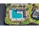 Aerial view of a refreshing community pool surrounded by lounge chairs and lush landscaping at 1057 Stanton Pl. # 1057, Myrtle Beach, SC 29579