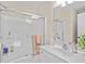 Clean bathroom showcases a tub with sliding glass doors, vanity with a mirror, and ample lighting at 107 Fox Den Dr., Murrells Inlet, SC 29576