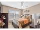 Cozy bedroom features a ceiling fan, window with blinds, and stylish decor at 107 Fox Den Dr., Murrells Inlet, SC 29576