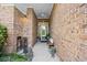 Covered brick entryway with a ceiling fan, bench seating, and a view of the front door at 107 Fox Den Dr., Murrells Inlet, SC 29576