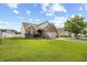 Well-maintained brick house with lush green lawn, mature trees, and attached two car garage at 107 Fox Den Dr., Murrells Inlet, SC 29576