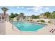 Community pool area with lounge chairs, palm trees, and a white fence creating a relaxing outdoor space at 107 Fox Den Dr., Murrells Inlet, SC 29576