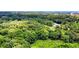 Aerial shot showcasing lush treeline with some city buildings visible in the distance at 1102 Indian Wells Ct. # 2, Garden City Beach, SC 29576