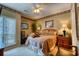 Comfortable bedroom with neutral carpeting, ceiling fan, and plenty of natural light at 1102 Indian Wells Ct. # 2, Garden City Beach, SC 29576