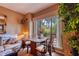 Dining area adjacent to living room with a view of the wooded landscape at 1102 Indian Wells Ct. # 2, Garden City Beach, SC 29576