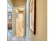 Inviting hallway with tile flooring leads to a cozy bedroom and bathroom at 1102 Indian Wells Ct. # 2, Garden City Beach, SC 29576