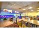 Bowling alley with multiple lanes, monitors, seating, and colorful decor in recreational facility at 1105 S Ocean Blvd. # 330, Myrtle Beach, SC 29577