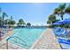 Outdoor pool with lounge chairs, beach umbrellas, and palm trees overlooking the ocean at 1105 S Ocean Blvd. # 330, Myrtle Beach, SC 29577