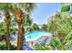 Aerial view of an outdoor pool area with lounge chairs, palm trees, and ocean views at 1105 S Ocean Blvd. # 330, Myrtle Beach, SC 29577