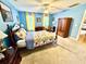 Comfortable bedroom with blue walls, neutral carpet, and natural light from sunny yellow curtains at 112 Robin Dr., Georgetown, SC 29440