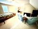 Large bedroom featuring carpeted floors, plenty of seating, and natural light, with an adjacent workspace at 112 Robin Dr., Georgetown, SC 29440