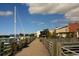 Picturesque view of a wooden boardwalk with railings leading to waterfront shops and restaurants at 112 Robin Dr., Georgetown, SC 29440