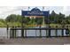 View of Harborwalk shopping and dining area next to water with a blue sign at 112 Robin Dr., Georgetown, SC 29440