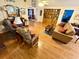 Cozy living room with hardwood floors, a mix of seating, and an open layout to the dining room at 112 Robin Dr., Georgetown, SC 29440