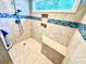 Bright shower with updated tile, a built-in bench, and a window bringing natural light into the space at 112 Robin Dr., Georgetown, SC 29440