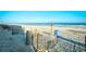 Beautiful beach scene with wooden fences lining the sandy path and ocean waves in the background at 1200 S Ocean Blvd. # 20506, Myrtle Beach, SC 29577