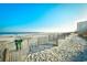 Scenic beach view with ocean, sandy shore, and distant buildings under a clear, sunny sky at 1200 S Ocean Blvd. # 20506, Myrtle Beach, SC 29577