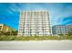 Beachfront condo building with multiple floors, each featuring a private balcony overlooking the ocean at 1200 S Ocean Blvd. # 20506, Myrtle Beach, SC 29577
