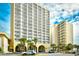 Stunning condo building with palm trees, covered entrance, and beautiful architecture at 1200 S Ocean Blvd. # 20506, Myrtle Beach, SC 29577