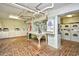 Laundry room with multiple washing machines and dryers, folding table, and brick flooring at 1200 S Ocean Blvd. # 20506, Myrtle Beach, SC 29577