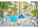 Relaxing pool area with palm trees, seating, lounge chairs, and a nearby condo building at 1200 S Ocean Blvd. # 20506, Myrtle Beach, SC 29577