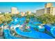Aerial view of a vibrant water park with slides and pools, set among resort buildings at 1200 S Ocean Blvd. # 20506, Myrtle Beach, SC 29577