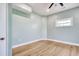 Light-filled bedroom with wood floors, a ceiling fan, and a large window at 125 Oak Bay Dr., Georgetown, SC 29440
