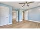 A bedroom with light blue walls features bright, neutral flooring and multiple doorways at 125 Oak Bay Dr., Georgetown, SC 29440