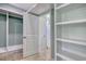 Walk-in closet with built in shelves, hanging space and tile floors with access to the bathroom at 125 Oak Bay Dr., Georgetown, SC 29440