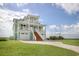 Two-story coastal home featuring a double garage and stair leading to a large porch at 125 Oak Bay Dr., Georgetown, SC 29440