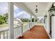 Spacious front porch featuring wood flooring and white railings overlooking the neighborhood at 125 Oak Bay Dr., Georgetown, SC 29440