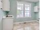 Bright laundry room with sink, window, tile floors, and room for washer and dryer at 125 Oak Bay Dr., Georgetown, SC 29440
