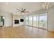 Bright living area featuring fireplace, hardwood floors, and sliding glass doors to the rear deck at 125 Oak Bay Dr., Georgetown, SC 29440