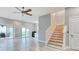 Open living room area with a staircase, outside patio access, and view of the kitchenette at 125 Oak Bay Dr., Georgetown, SC 29440